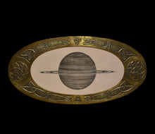  Saturn, presented in an brass Arts & Crafts frame, circa 1900